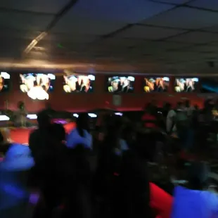 a crowd of people watching televisions