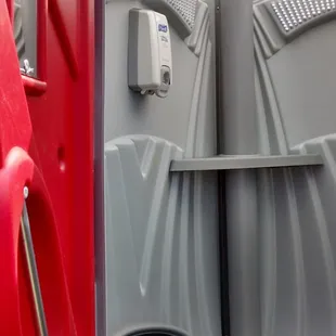 a public toilet with a red door