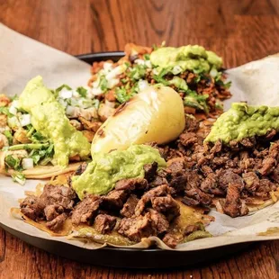 4 tacos with guacamole on top.  Medium rare on the ribeye tacos!