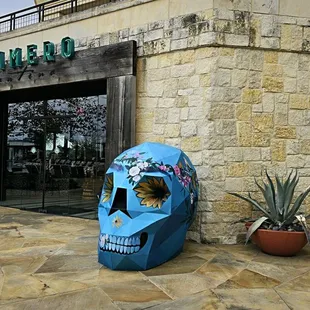 a blue skull outside a restaurant