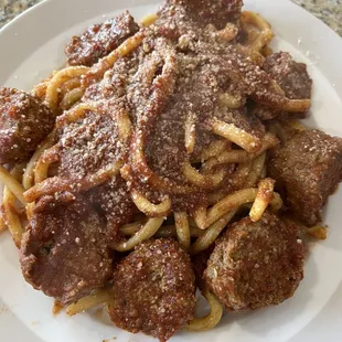 a plate of meat and pasta