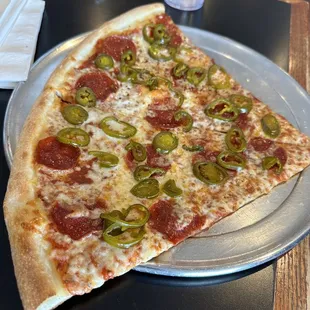 a slice of pepperoni and jalapeno pizza