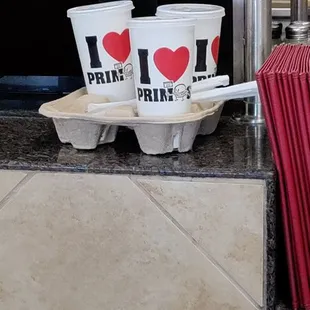 two cups of coffee and a red umbrella