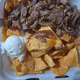 What kind of nachos are these. I asked for cheese and Pico on the side but cheese was cold, meat shredded and 2 slice of avocado.