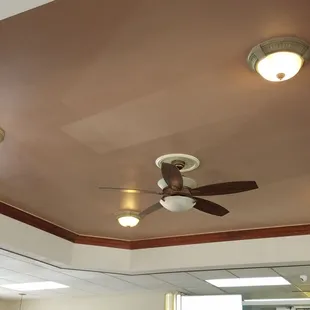 It's a ceiling with decorated lights around a central fan.