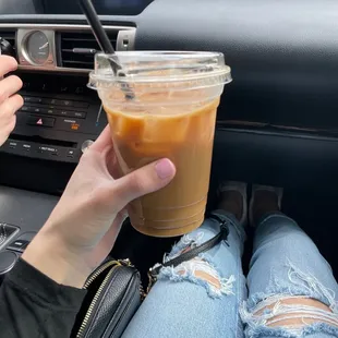 a person holding a drink in a car