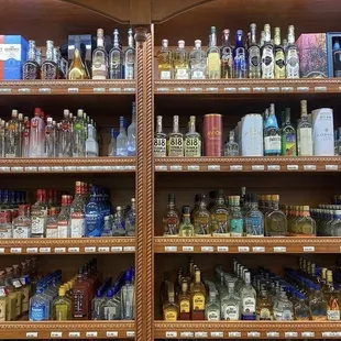 a shelf full of liquor bottles