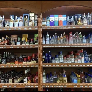 a shelf full of liquor bottles