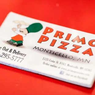 a business card on a red table