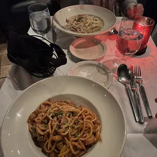 a plate of pasta and a glass of water