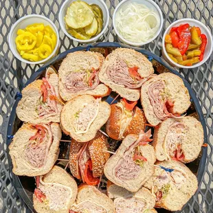 a platter of sandwiches and pickles