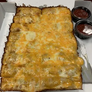 a cheesy pizza in a box