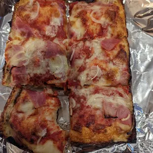 Small ham and onion pizza with almost no cheese, but the appropriate amount according to the person at the counter.