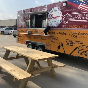 a picnic table and food truck