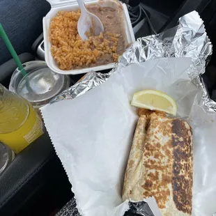 Pictured: Half shrimp of a full burrito with beans and rice.