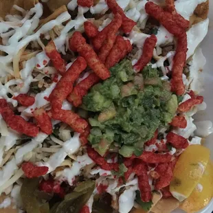 Carne asada nachos with everything on it plus hot Cheetos.