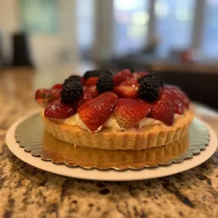 Custom fruit tart with strawberries, raspberries, and blackberries.