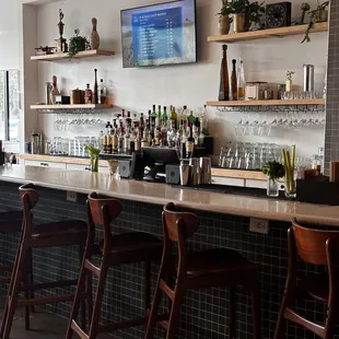a bar with wooden chairs
