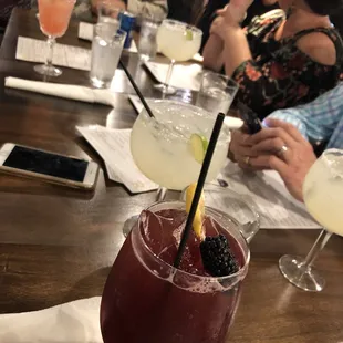 eople sitting at a table with drinks