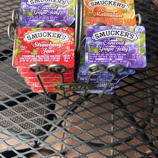 three packets of smuckers on a table