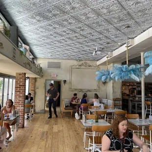 people sitting at tables in a restaurant