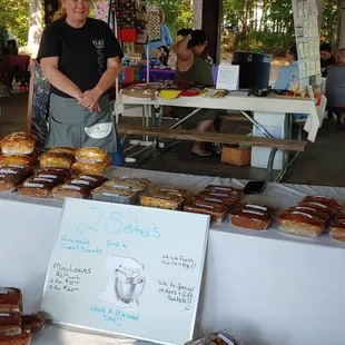  man standing in front of a table of donuts