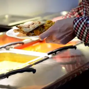 a person holding a plate of food