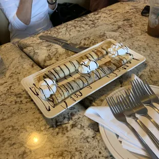 a woman taking a picture of a dessert