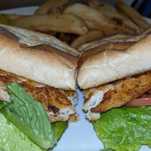 a fish sandwich with lettuce and tomato