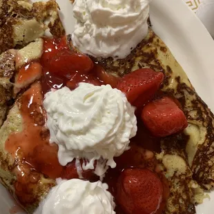 Crepes with strawberries along with happy whip cream