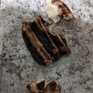 Our &quot;order&quot; of pita... Burnt to a crisp, hard as a rock.