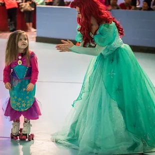 Two mermaid princesses dance at the Carousel Skate Rink in Wichita.