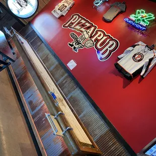 a red wall with neon signs