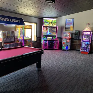 a pool table and arcade machines