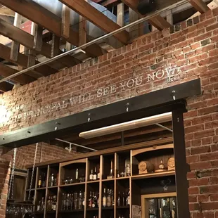 a brick wall and exposed ceiling