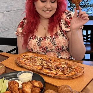 a woman sitting at a table with food