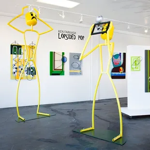 Ken Farkash's Lopsided Pop featuring the "The Spectacle" yellow sculptures