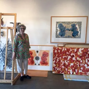 Photo of the gallery during setup, with gallery owner and artist, Priscilla Fowler