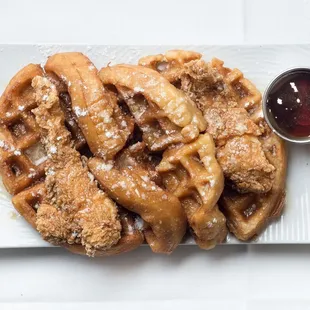 a plate of waffles with syrup