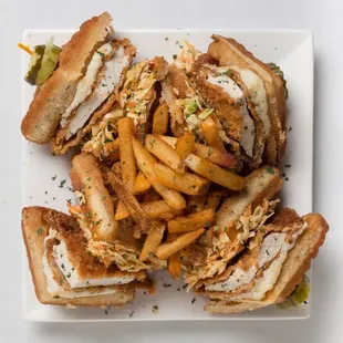a plate of sandwiches and french fries