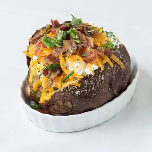 a baked potato topped with cheese and bacon