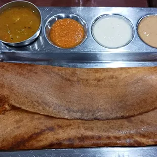 Soft and crispy Dosa topped with ghee and their special Babai Karam podi masala. Spicy delicious goodness.