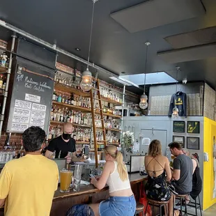 people at a bar with a bartender