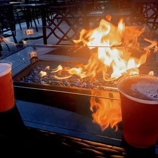 a fire pit with two beers