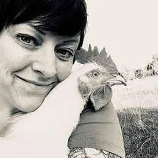 a woman holding a chicken