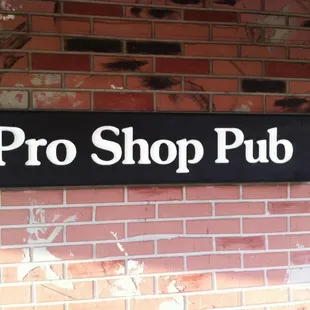 a sign on a brick wall