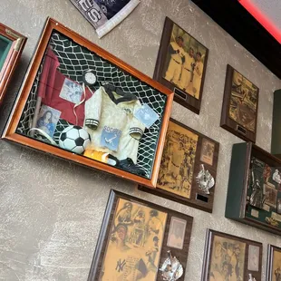 a wall of framed memorabilia