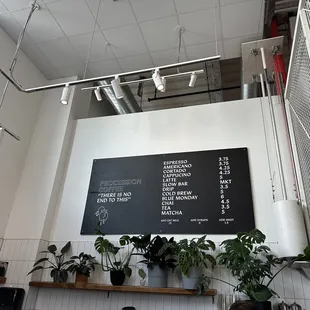 a menu on the wall of a coffee shop