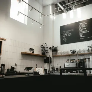 a coffee shop with a menu on the wall