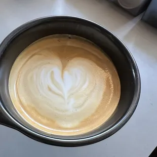 a cup of coffee with a heart drawn in it